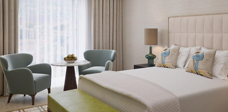 Luxury Suite Bedroom Illustration: King bed and window seating area at The River Lee Hotel