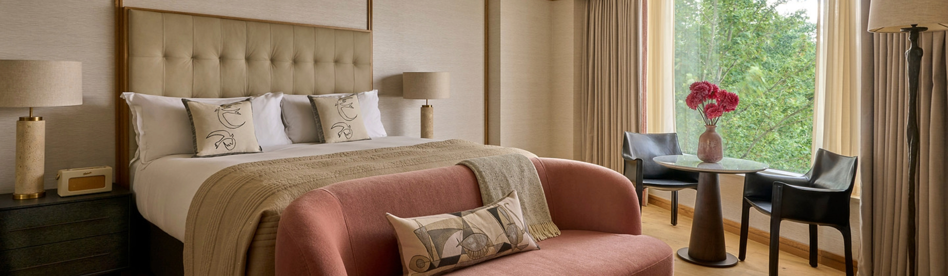 Studio Suite bedroom setup with a peach sofa in front of a king bed.