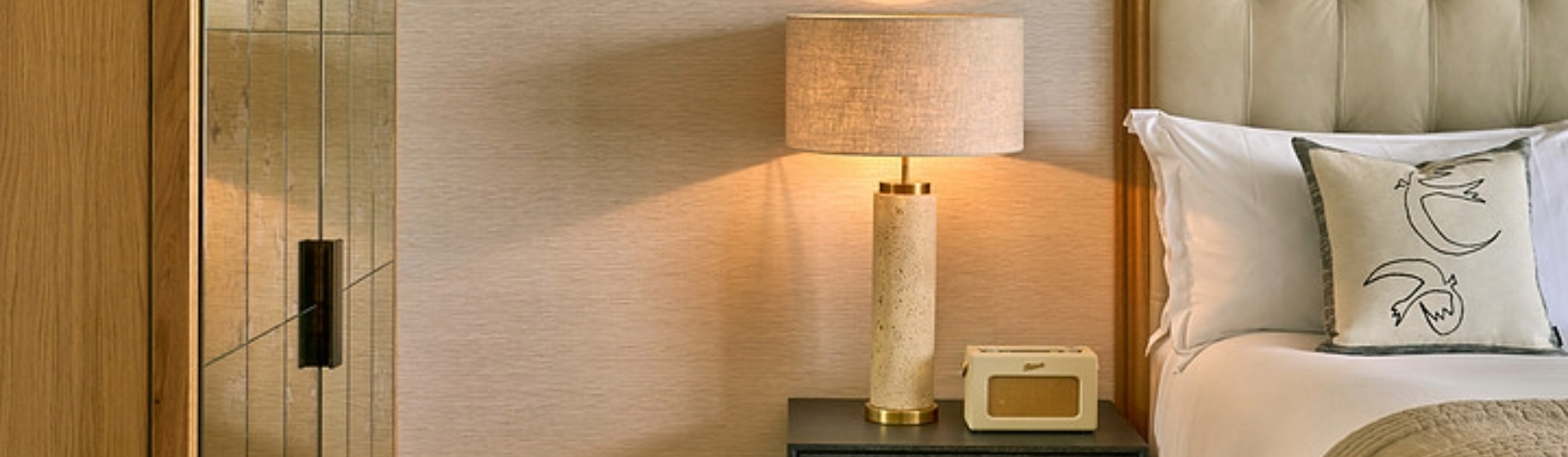 Studio Suite at The River Lee Hotel featuring a close-up view of the bed and a stylish bedside lamp.