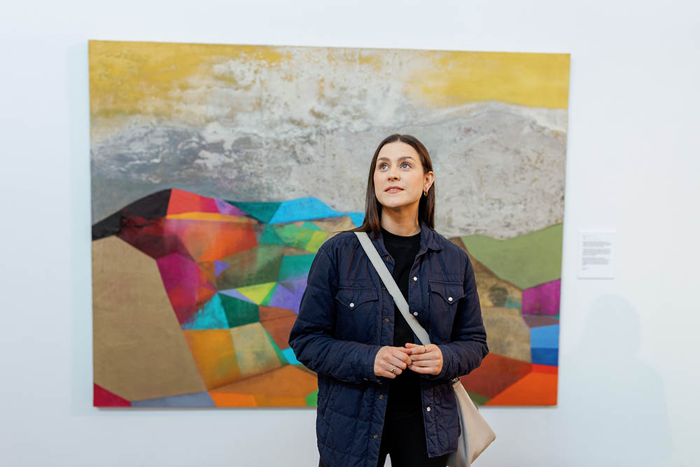 Jo Linehan standing in front of a painting