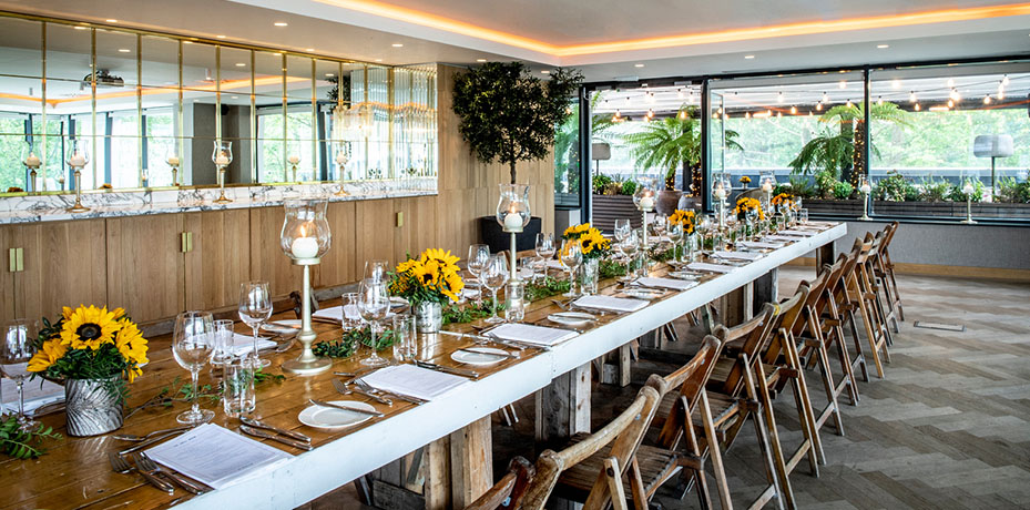 Long table decorated with sun flowers
