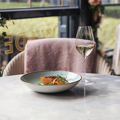 A salmon dish with a crisp white wine served in WILDE