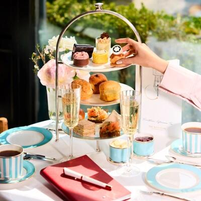 Luxury afternoon tea at The Westbury: The artisanal dessert from a tiered stand alongside sparkling champagne and traditional tea service.
