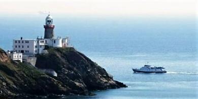 Dublin Bay Cruise boat sailing round the lighthouse at Howth