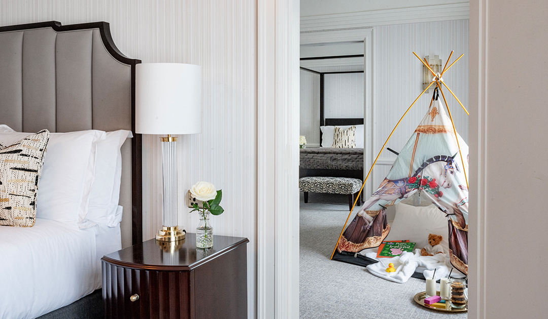 Luxury Signature Suite at The Westbury showing an interconnecting layout. A decorative play tent is set up on the four-poster bed, highlighting the hotel’s bespoke family-friendly amenities for kids