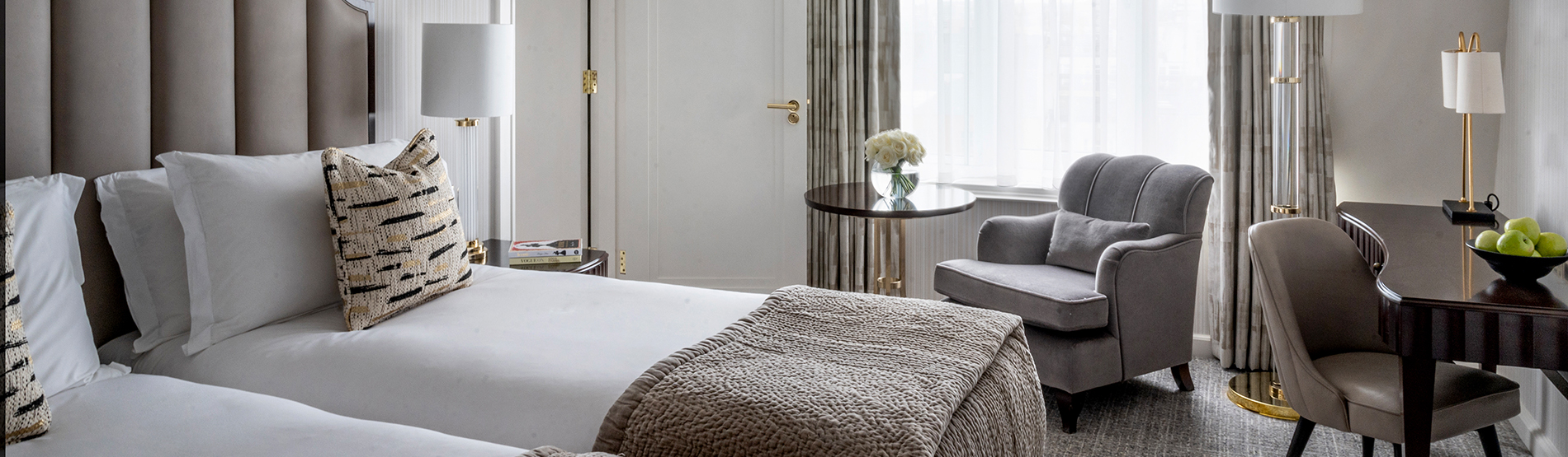 Two twin beds in the bright, luxurious Westbury Twin Room, featuring a dedicated workspace, contemporary design