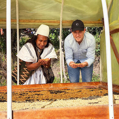 Farmers showing roasted coffee beans