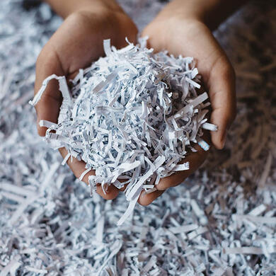 A hand full of shredded paper