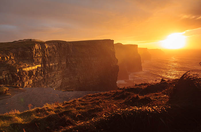 The beautiful Cliffs of Moher bathed in golden sun