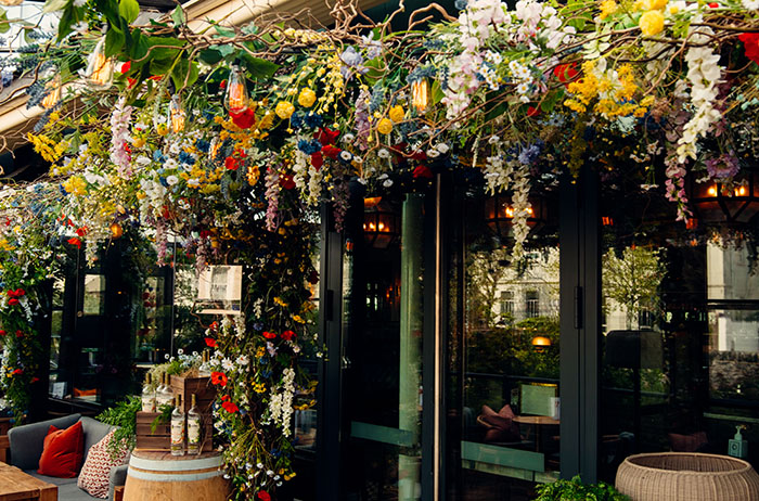 A canopy of flowers hang overhead at the Meadow Terrace at The River Club