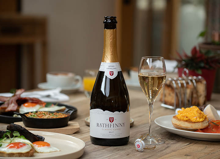 A table with brunch and an open bottle of Rathfinny Classic Cuvee
