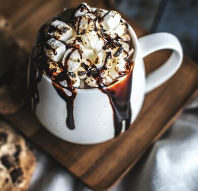 mug of hot chocolate with marshmallows and chocolate overflowing